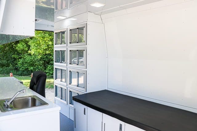 Storage unit, exam bed and office space inside Mobile Medical Clinic van