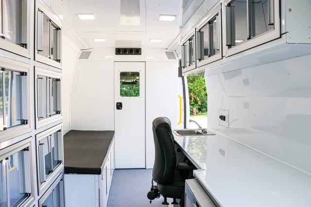 Mobile Medical Clinic Van with desk space and secured rolling chair.