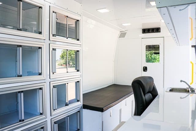 Mobile Medical Clinic Unit interior with storage, bed, and office space