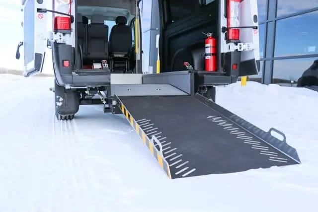 Wheelchair van ramp with grab handles.