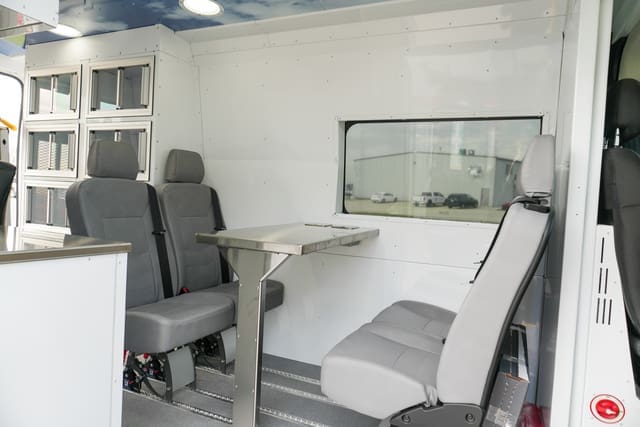Table and seating in a mobile outreach unit from AVAN Mobility